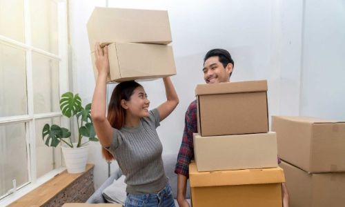 Young couple packing boxes to put into self storage