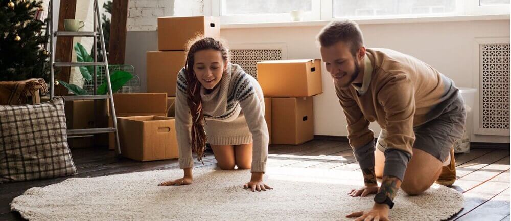 storage for renters a young couple unpacks a rug in their new apartment