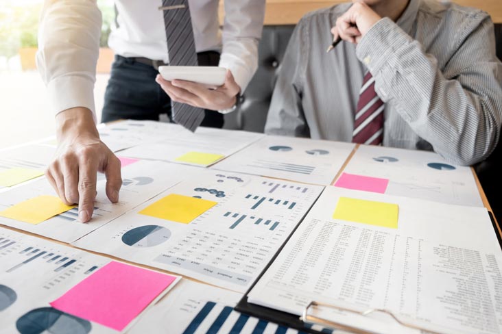 Business professionals review important documents before packing for self storage.