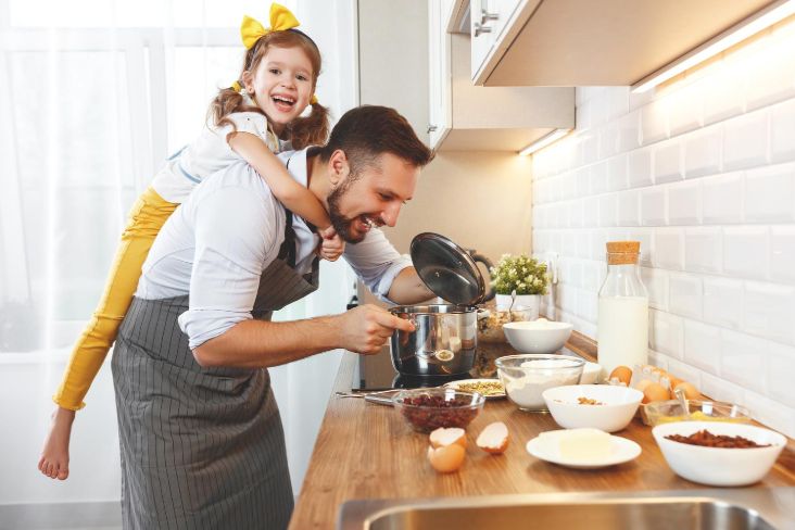 Family cooks with kitchen items prior to moving utensils into storage