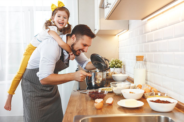 Family cooks with kitchen items prior to moving utensils into storage